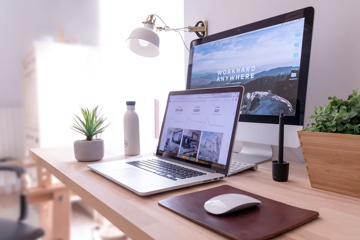 Minimalist workspace with laptop and notebook representing focused work