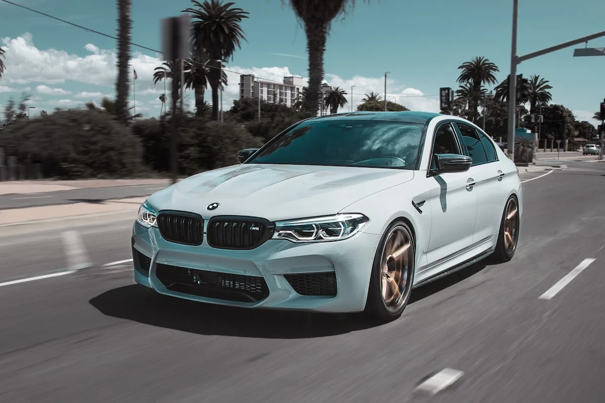 BMW car driving on an empty road at dusk