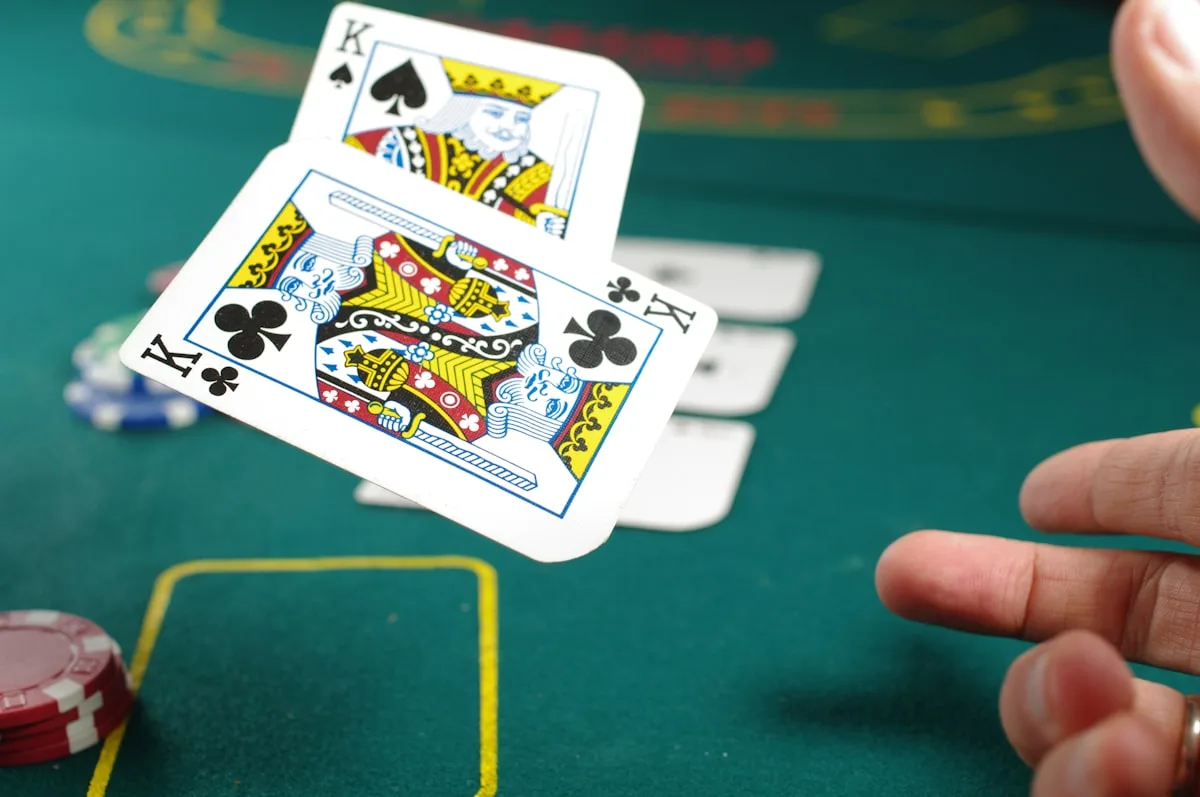 Playing cards spread on a dark surface, suggesting games and irreverent fun