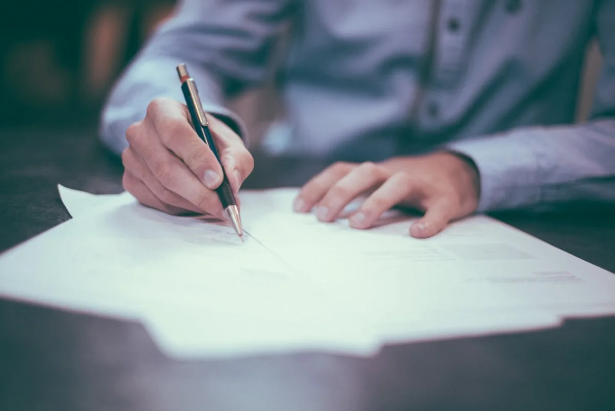 Car insurance documents and keys on a desk