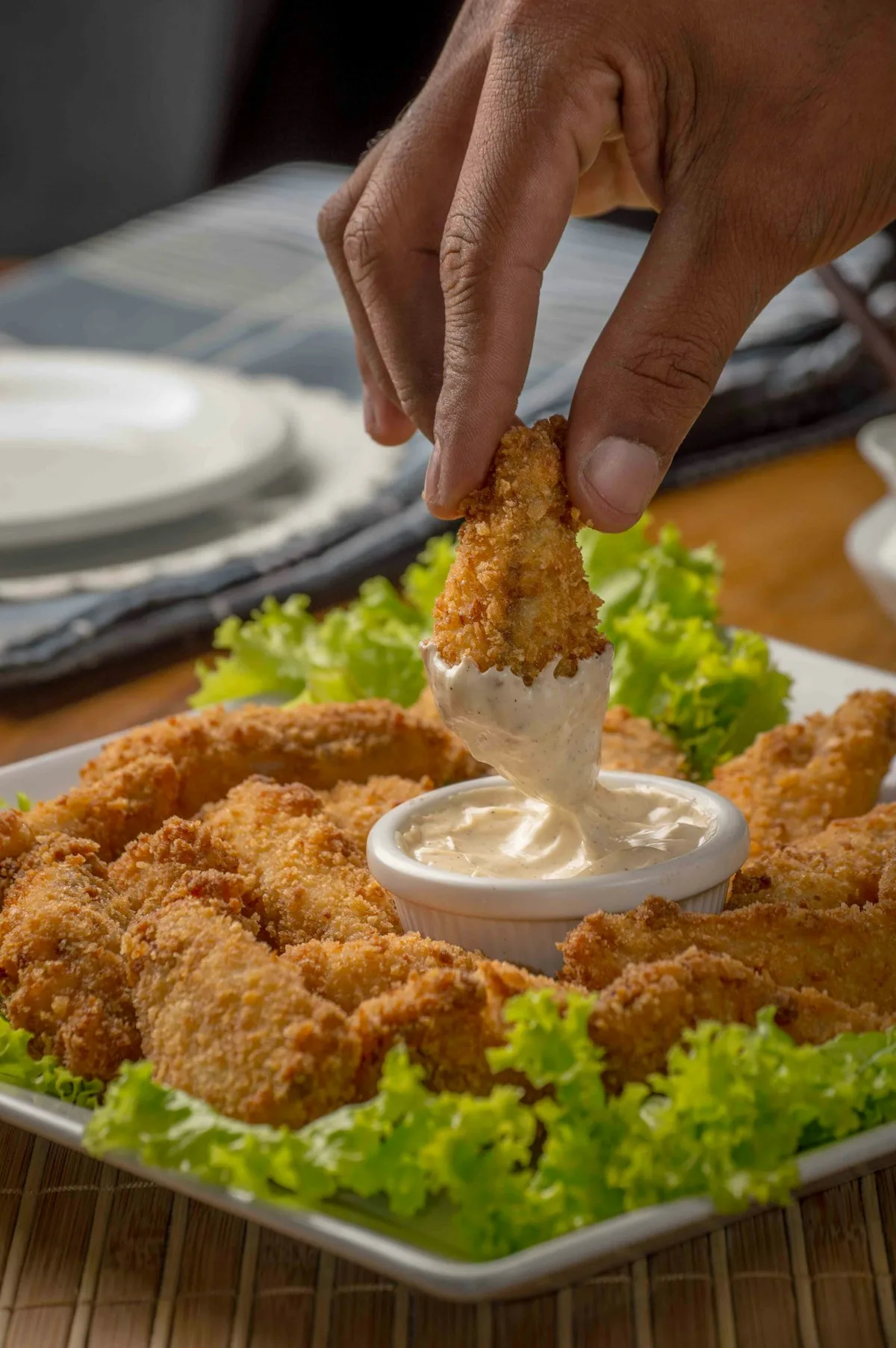 Fried chicken in a red and white bucket on a dark background