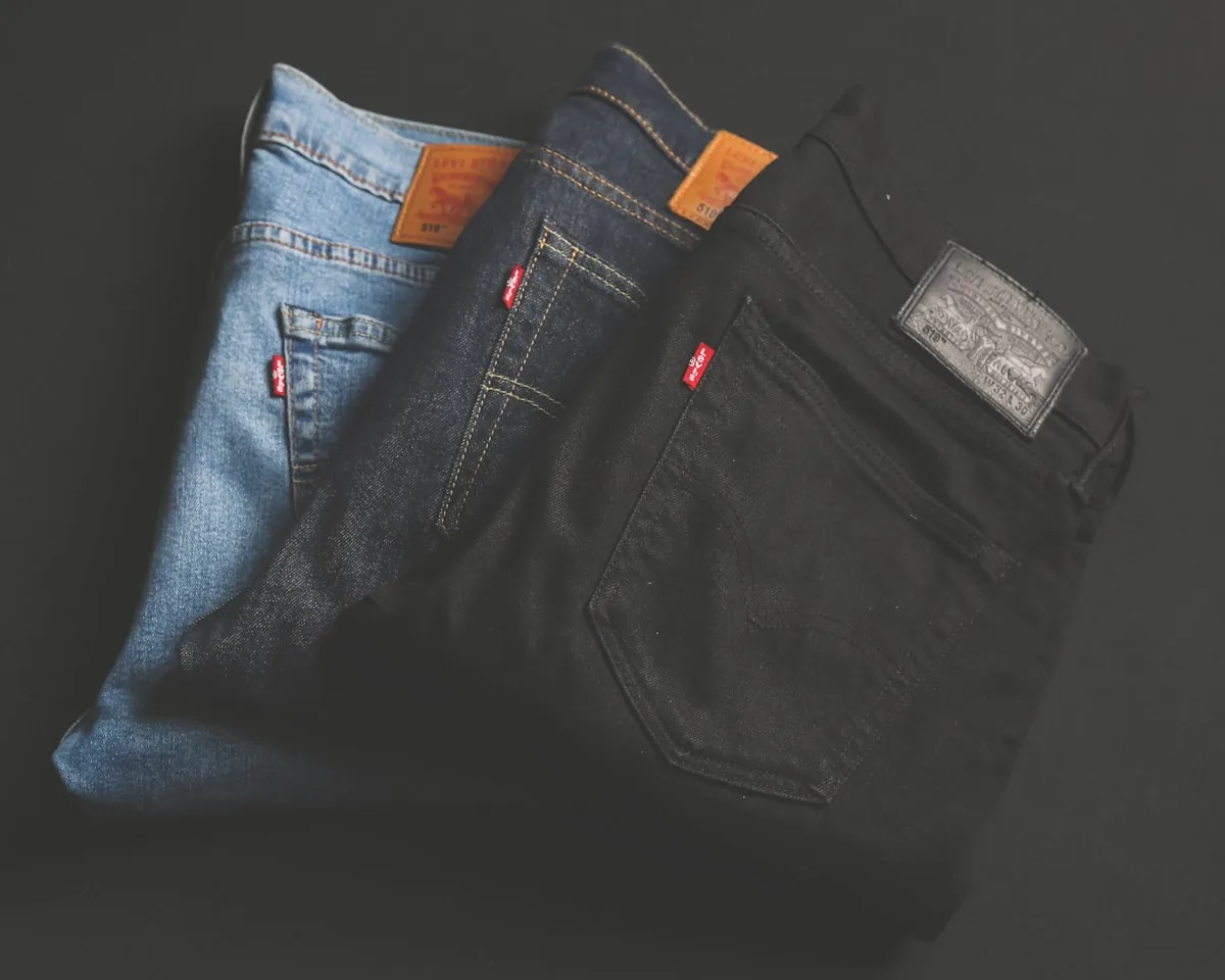 A pair of worn Levi's 501 jeans folded on a wooden surface