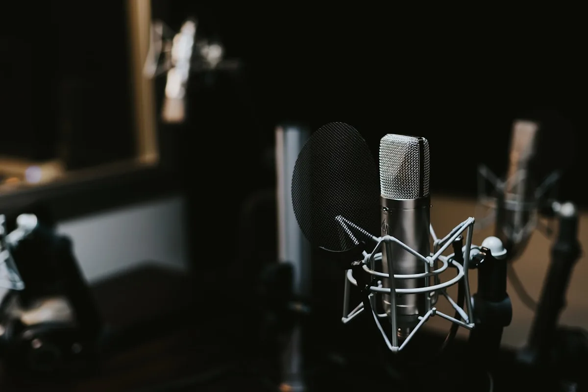 Vintage-style microphone in a podcast recording setup with warm light