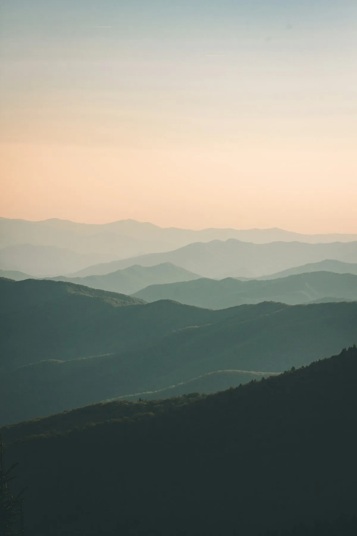 Wide open American landscape at golden hour, the kind of terrain the Marlboro Man made iconic