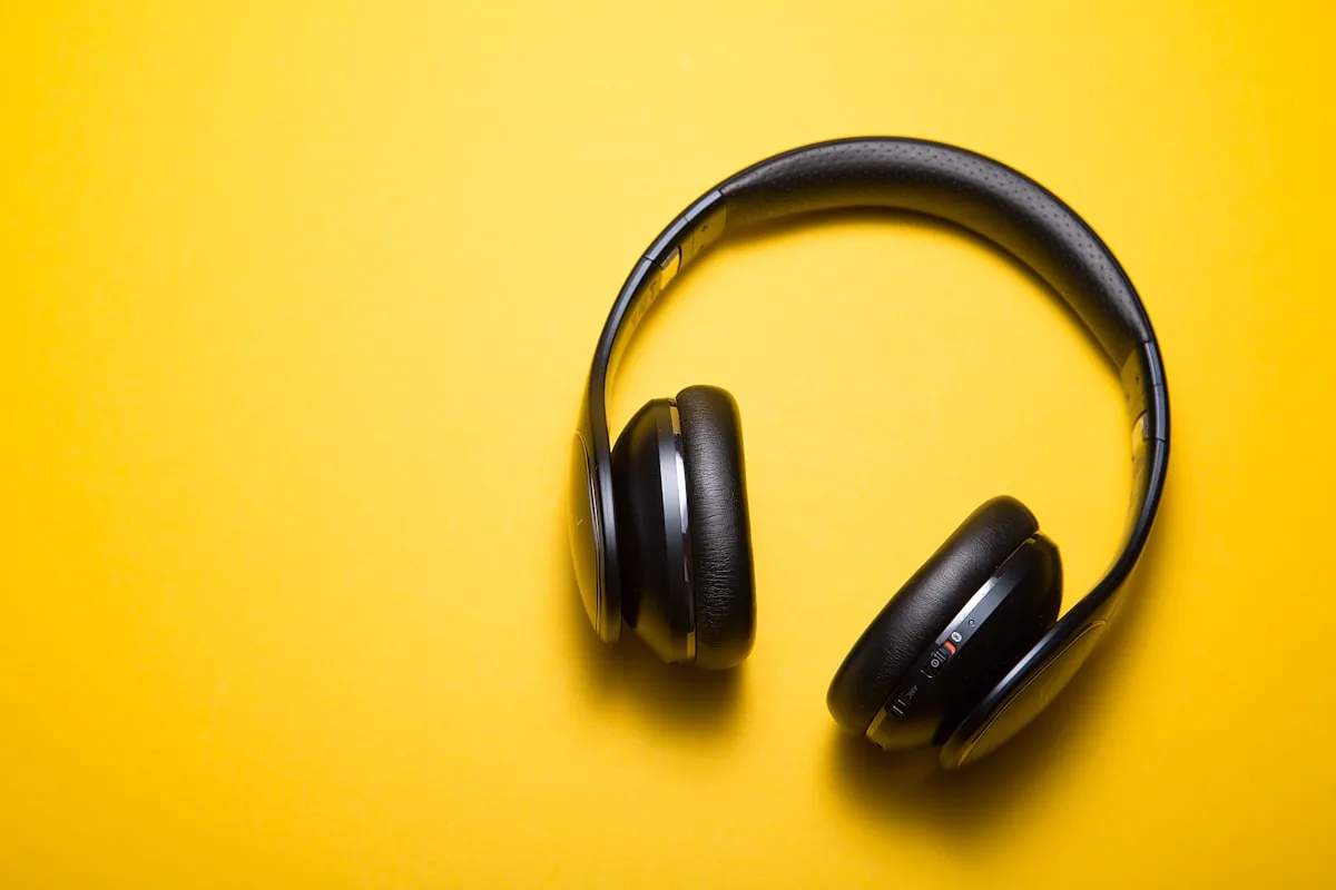 Vintage MP3 player and headphones on a wooden desk