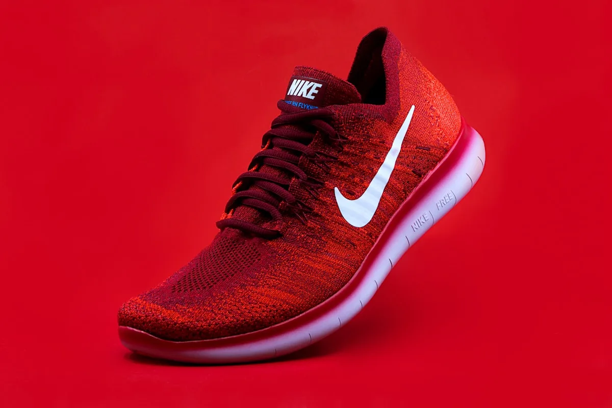 Nike sneakers on a bold graphic background representing the brand's identity