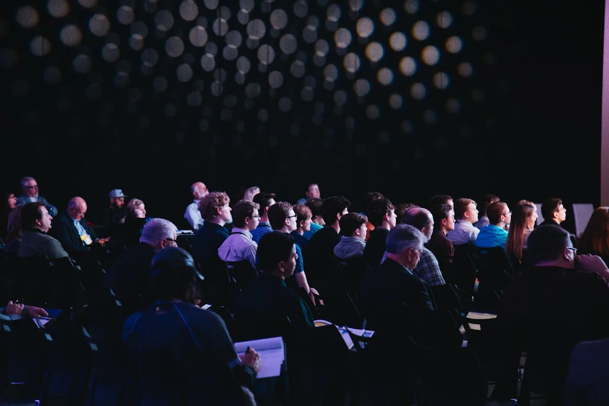 Large conference hall with thousands of attendees at a tech event