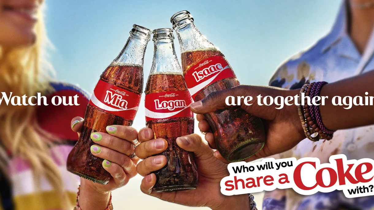 Glass Coca-Cola bottles on a shelf, representing the Share a Coke personalization campaign