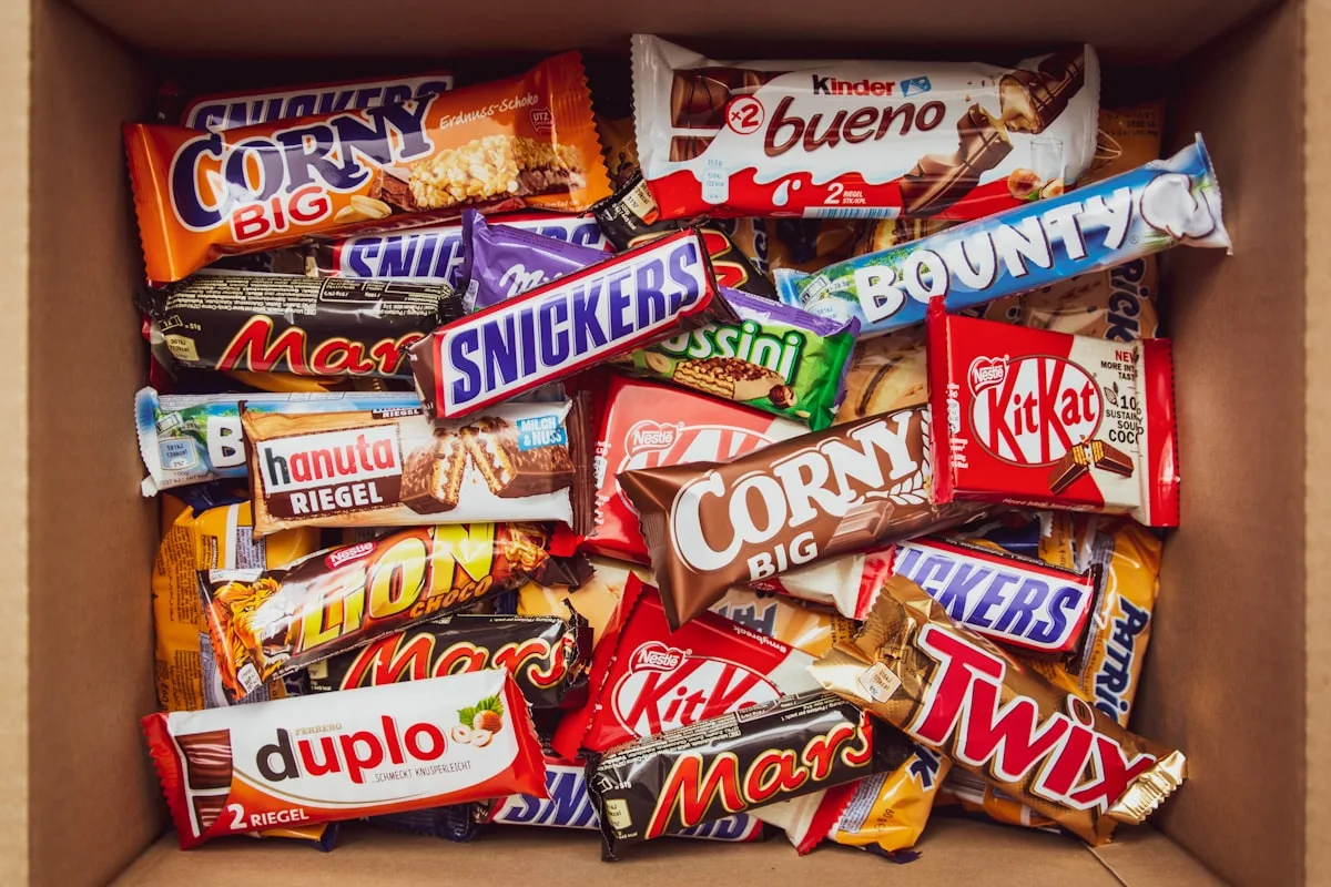 Assorted candy bars on a colorful background
