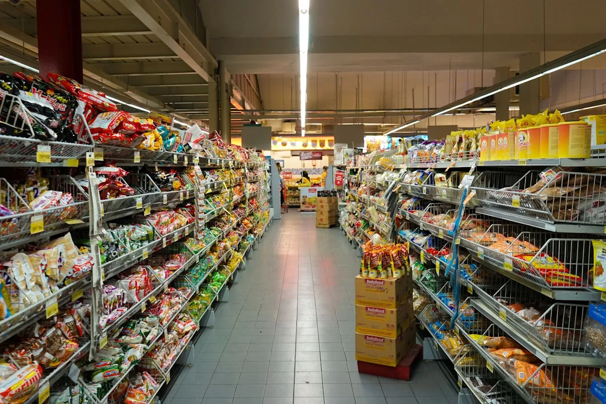 Wide retail store aisle with product shelves and bright lighting