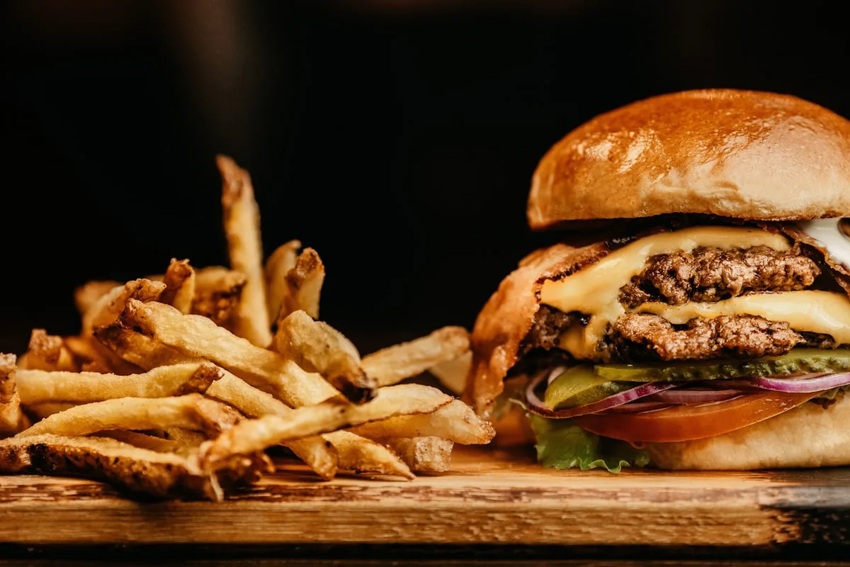 Fast food burger and fries on a tray, representing the quick service restaurant industry
