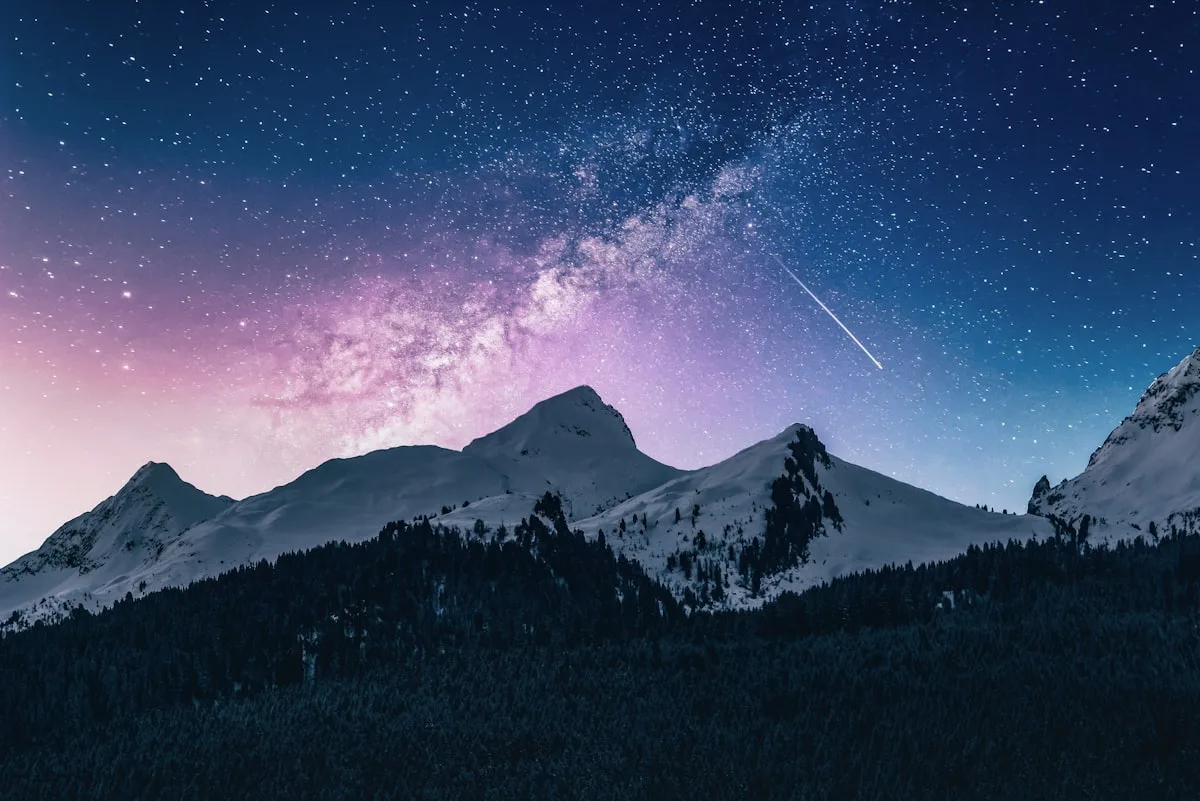 A mountain peak emerging above clouds representing brand essence rising above functional attributes