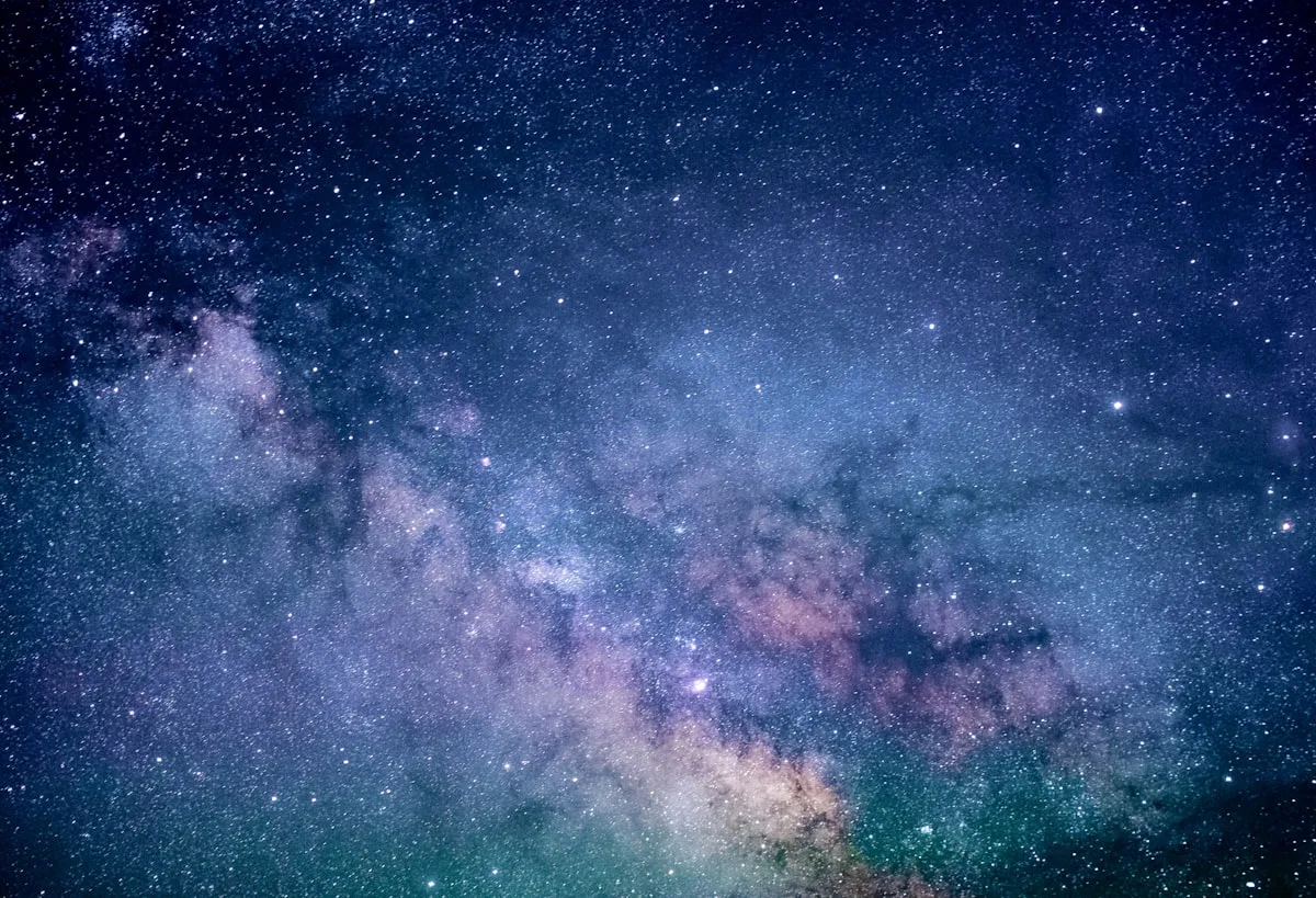 A clear night sky with a single bright star visible above a dark mountain ridge