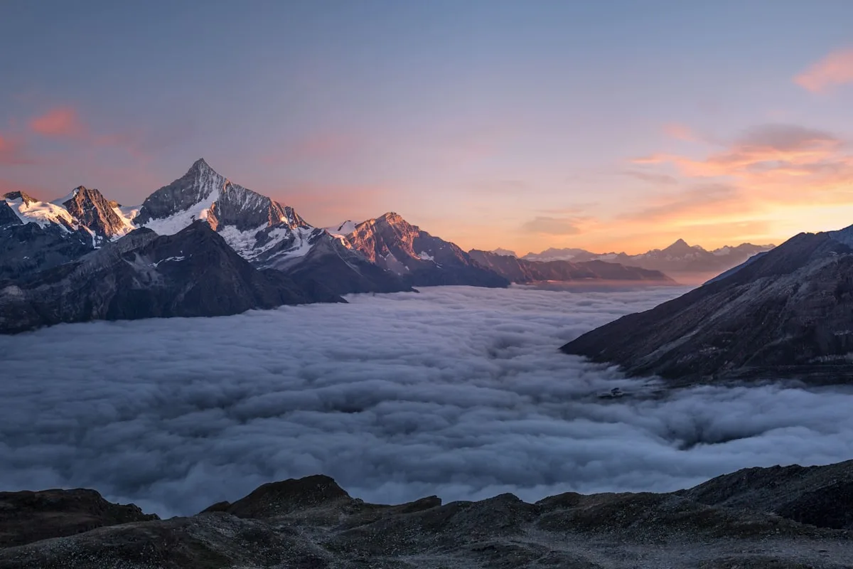 Three successive mountain peaks at dawn representing sequential but overlapping strategic horizons
